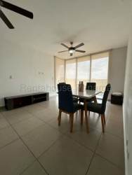 Open dining area with glass table, large window, ceiling fan in Panama Pacifico PH Mosaic apartment