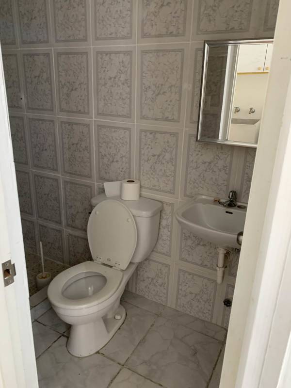 Modern compact kitchen with granite countertops, white cabinetry in PH Brisas de San Fernando Panama City