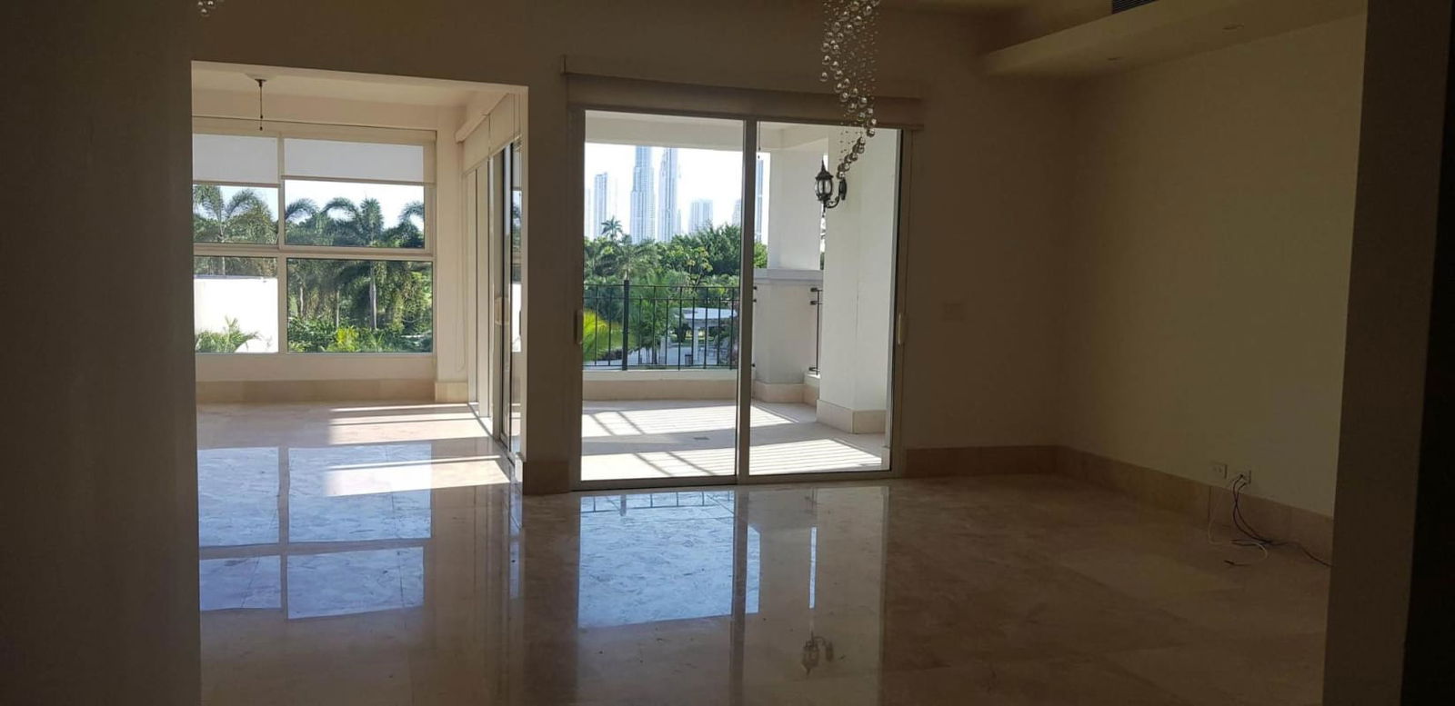 Bright living room with marble floors, floor-to-ceiling windows, balcony access in PH The Reserve Santa Maria Panama