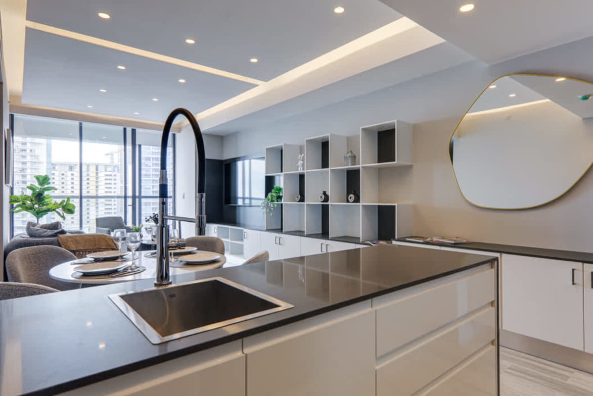 Modern walk-in closet with custom shelving connecting to marble bathroom at Nuovo Residences Panama City