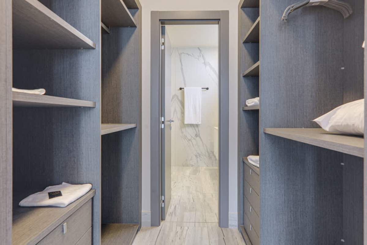 Living room with modern decor, dining area, panoramic windows at Nuovo Residences Bella Vista