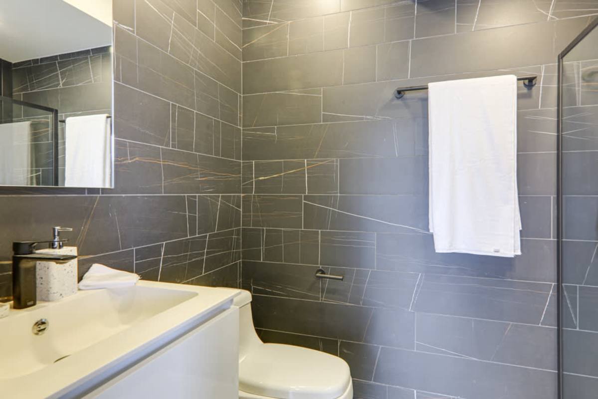 Bedroom with wide window and built-in closet overlooking city skyline at Nuovo Panama