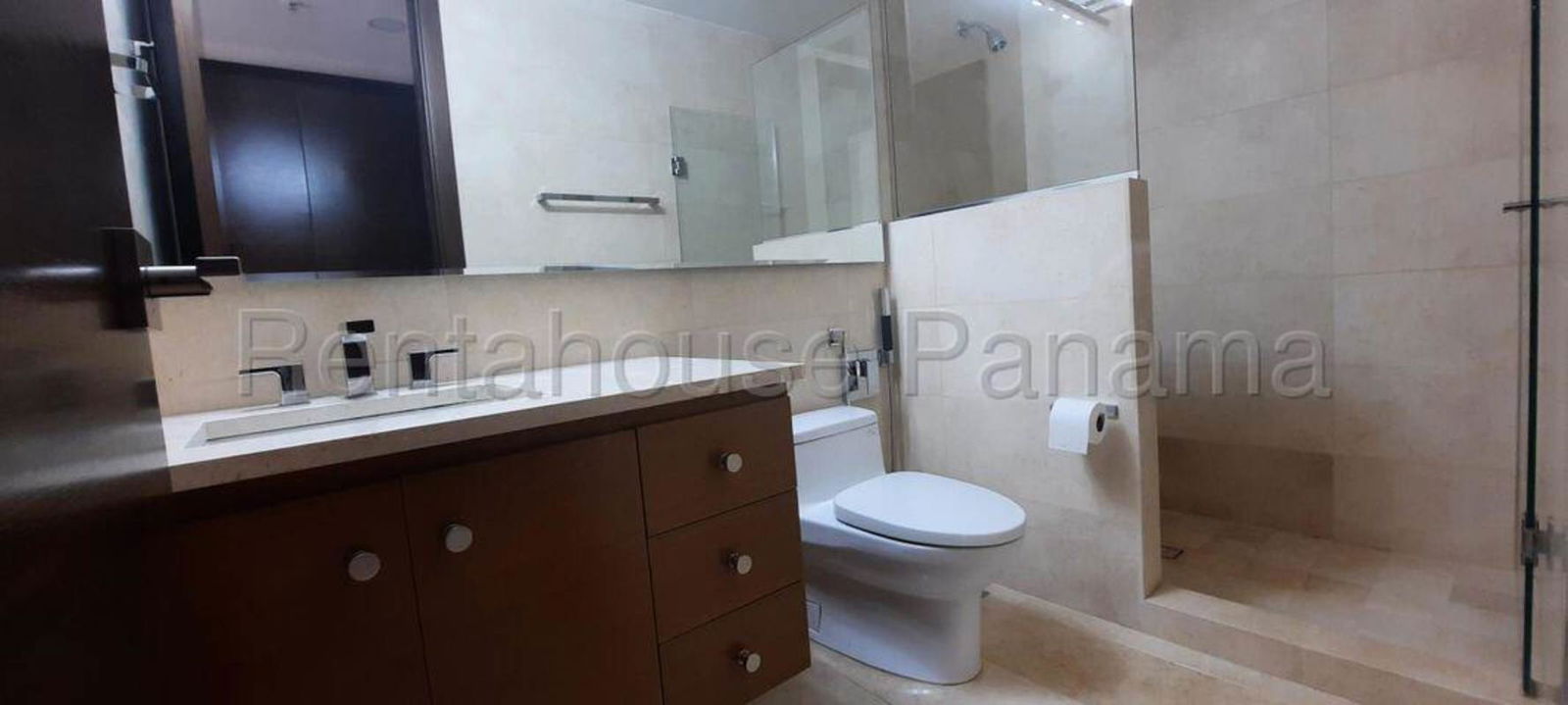 Modern marble bathroom with glass shower enclosure in Santa Maria luxury apartment Panama