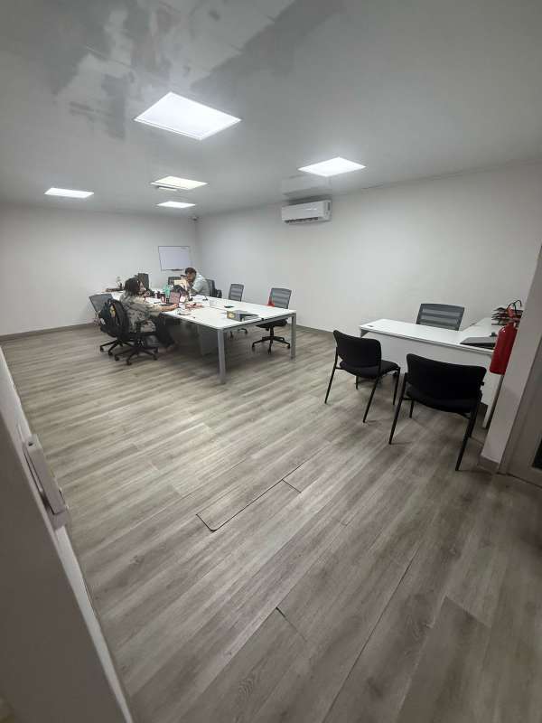 Meeting room with large table, chairs, TV and whiteboard inside commercial building Panama