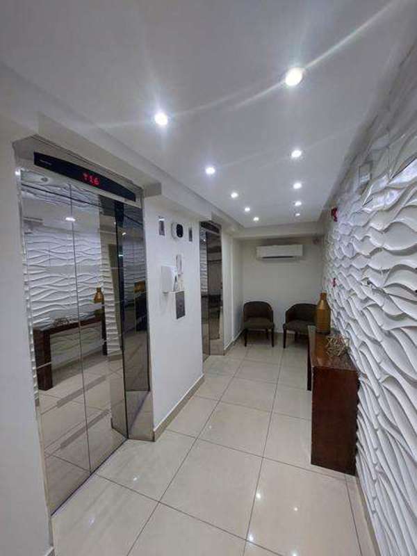 Living room with large sliding glass doors opening to balcony in PH Green Park Villa de Las Fuentes Panama City