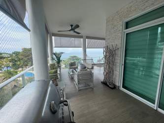 Large covered balcony overlooking ocean with lounge area at PH Bijao Residences Panama beach apartment for sale