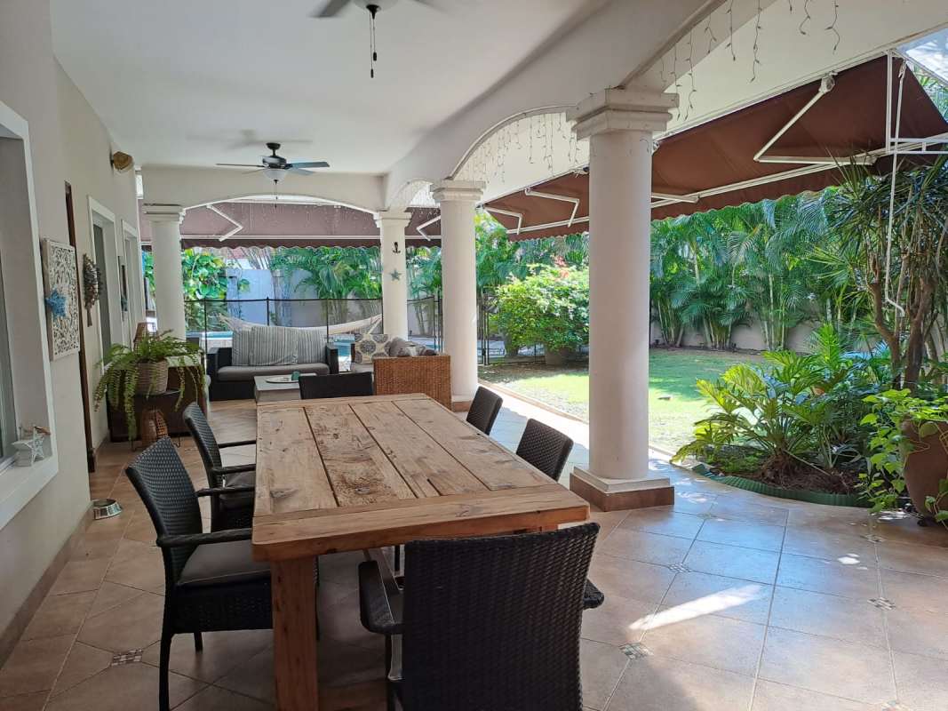 Outdoor terrace with dining and garden Costa del Este luxury house Panama