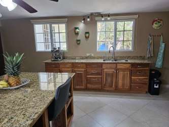 Kitchen with granite island wood cabinets modern appliances in luxury house El Valle Urbanización Gaital