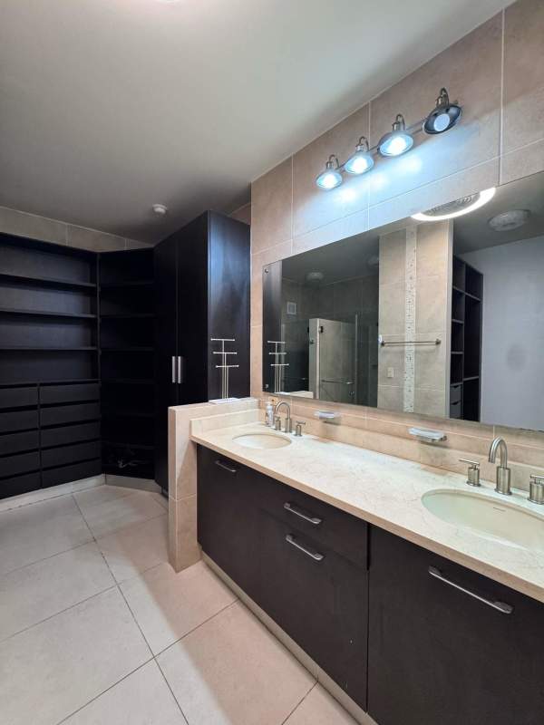 Bathroom with double sink, granite countertop, glass shower in Embassy Club Panama