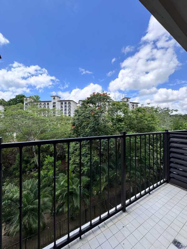 Private balcony with metal railings overlooking garden views in Embassy Club Panama City