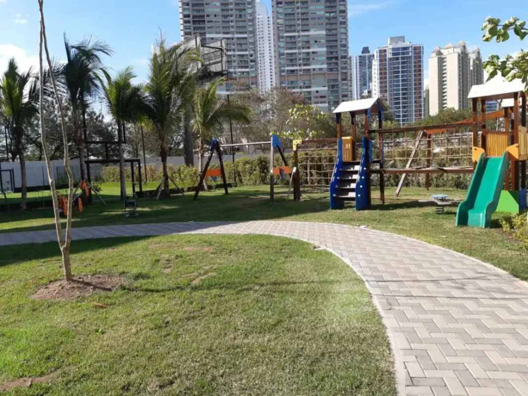 Stylish penthouse living room with large green sofa, floor-to-ceiling windows PH Country Club Costa del Este Panama