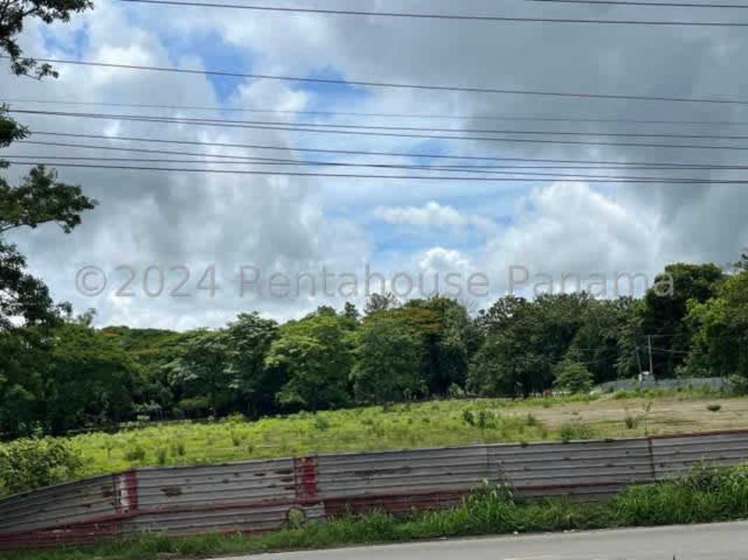 Large plot of green grassy industrially zoned land fenced in Pacora Panama