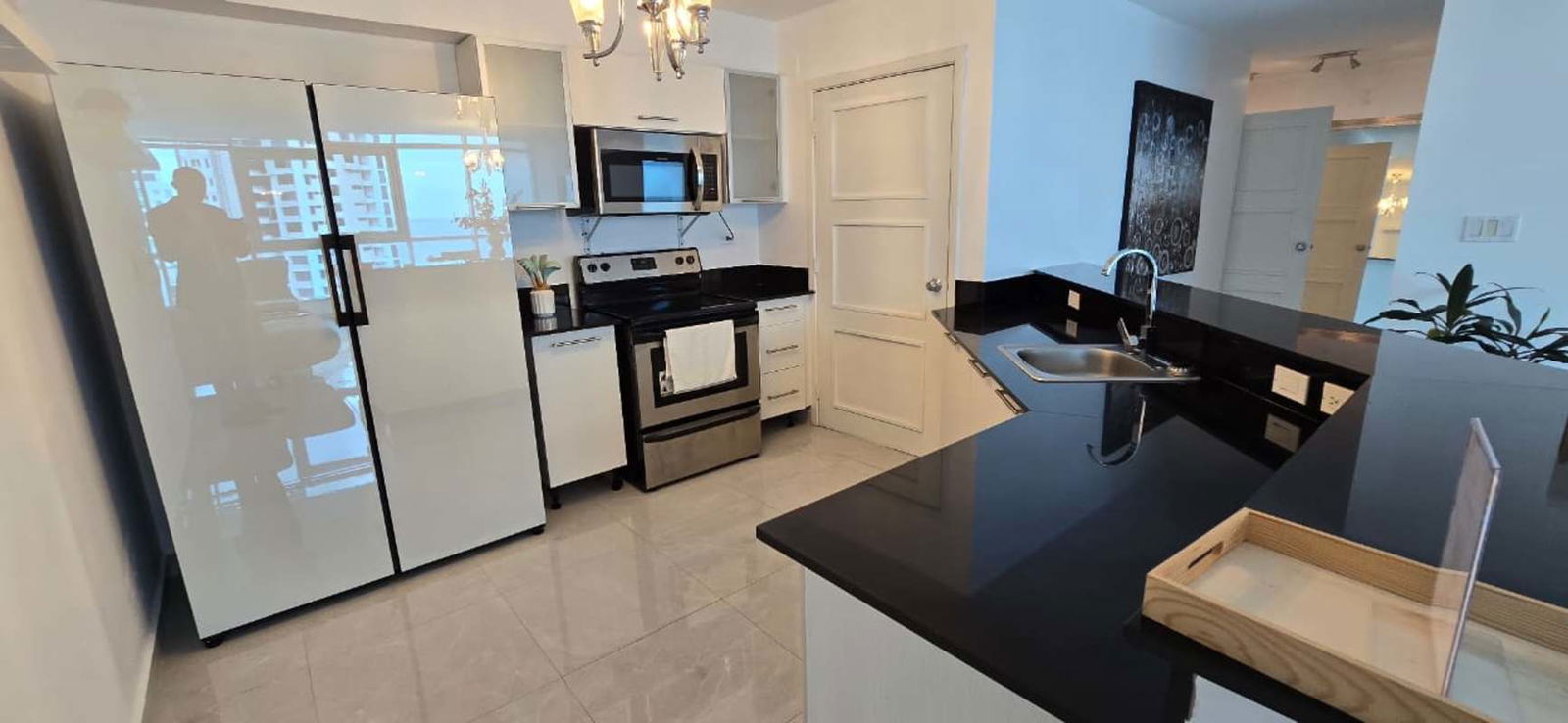 Private balcony with glass railing and ocean city views in PH Riverside Panama