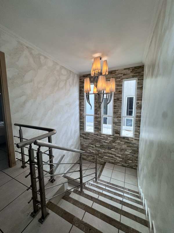 Interior staircase with metal railing and stone accent wall Brisas del Golf