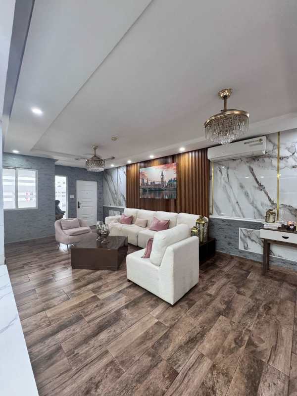 Living room with accent marble wall and luxury furnishings in Brisas del Golf Panama