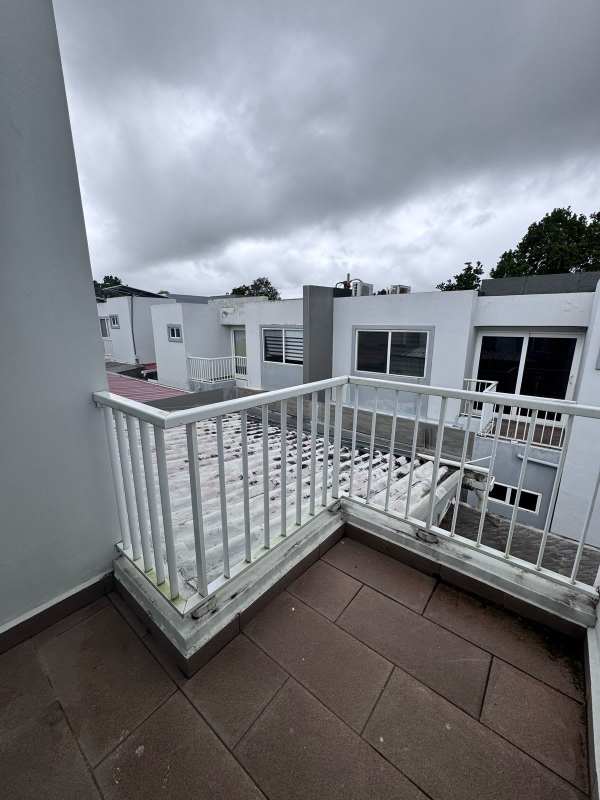 Small balcony overlooking gated neighborhood in Brisas del Golf Panama City