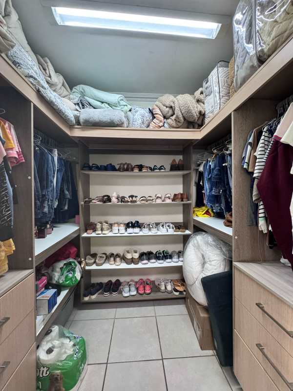 Large walk-in closet with shelves and storage in modern house Panama