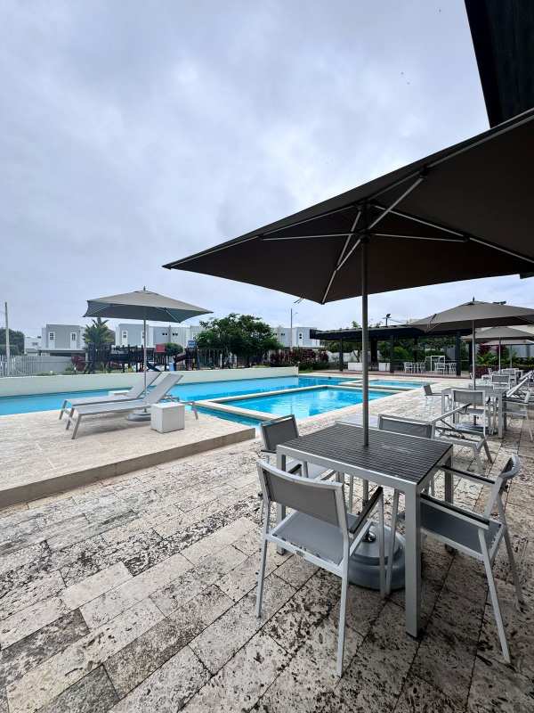 Swimming pool with lounge chairs and umbrella Paseo del Norte Brisas del Golf Panama