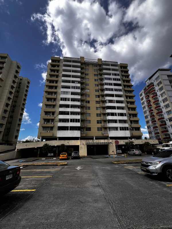 Modern mid-rise apartment building facade with parking area in Río Abajo Panama