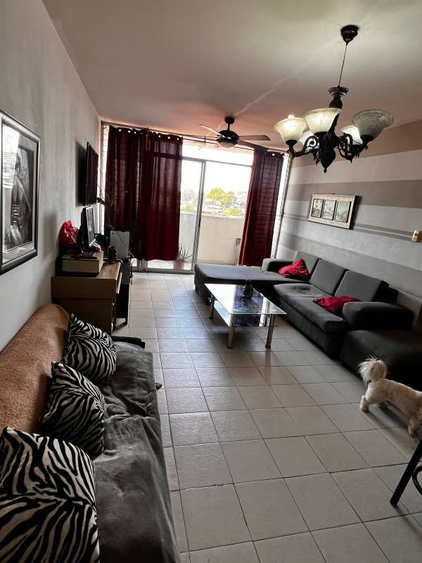 Living room with sliding doors to balcony in apartment for sale Río Abajo Panama