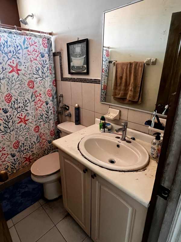 Small bathroom with colorful shower curtain and bathtub Río Abajo Panama