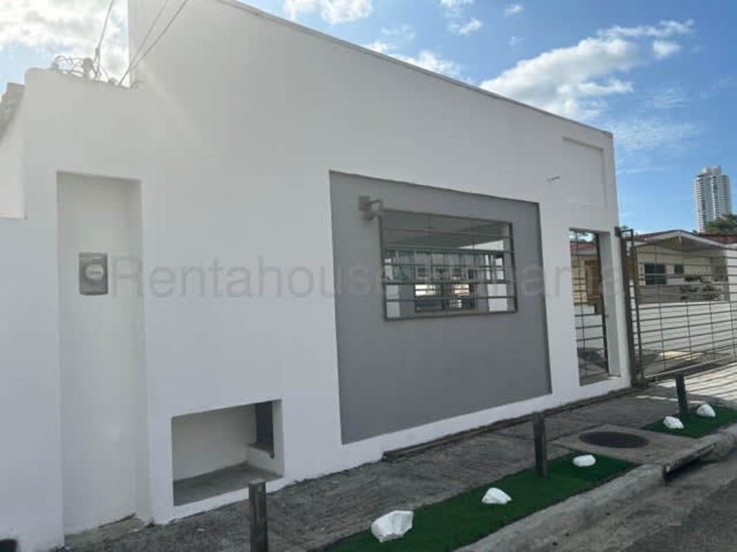 White facade with security bars and landscaping Chanis house Panama