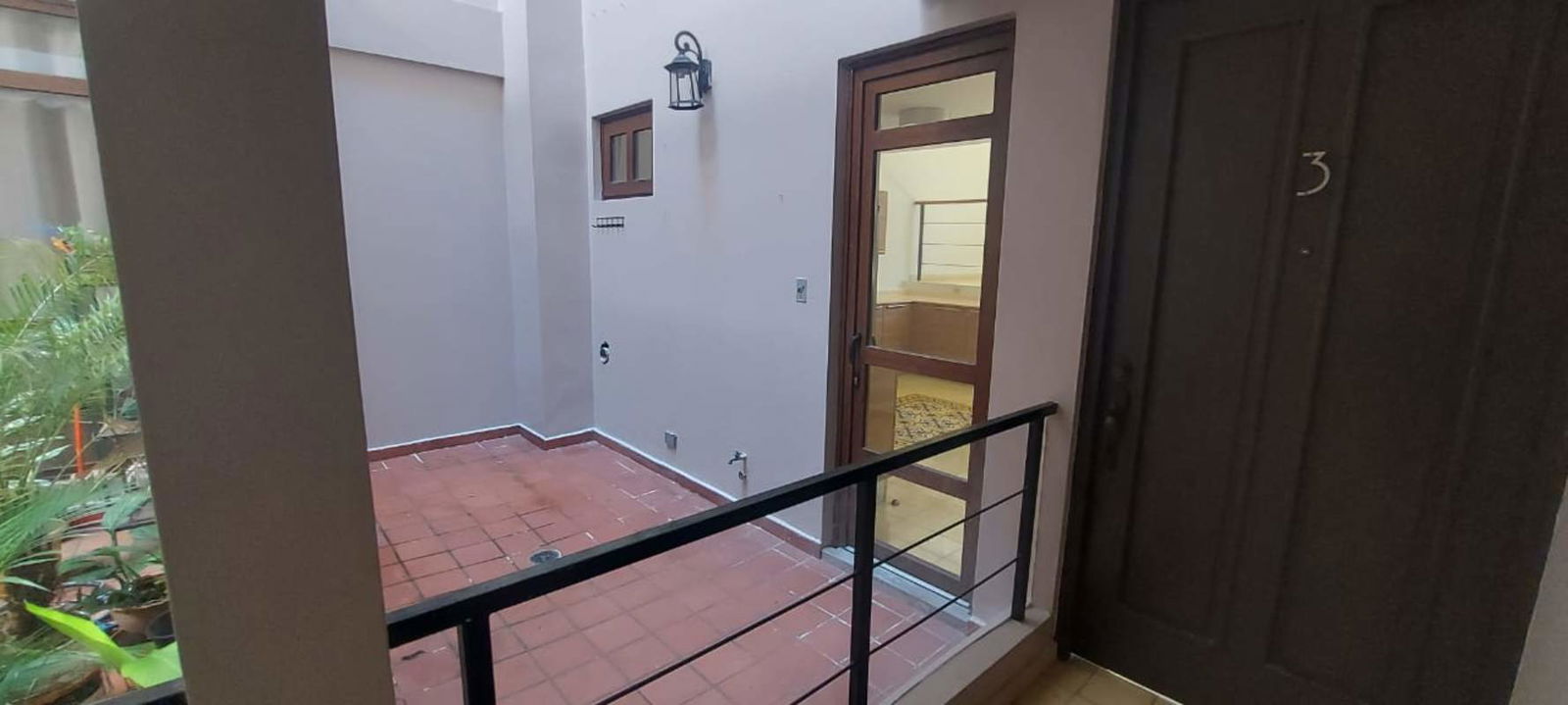 Double height living room with decorative tile floors, colonial windows, high ceilings in Casco Viejo apartment for rent Panama