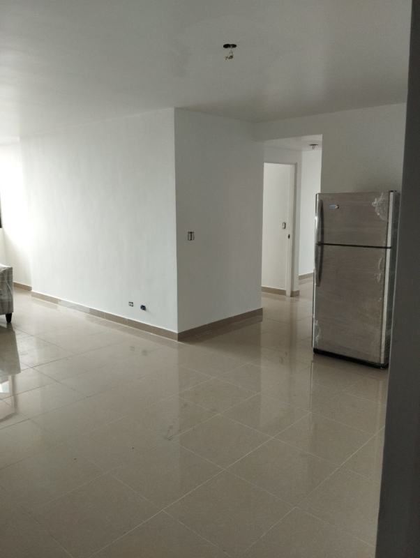 Minimalist kitchen with ceramic tiles and stainless appliances in Panama City apartment