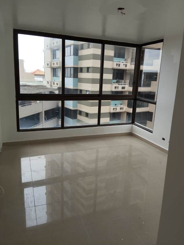 Open modern living area with tiled floors and corner windows in PH San Francisco Bay Panama