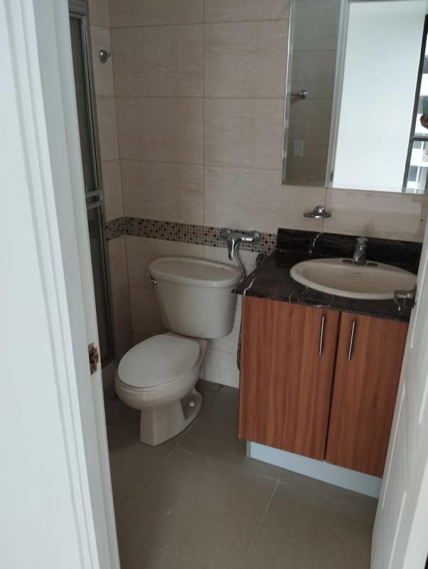 Modern bathroom with mosaic tiles and glass shower in Panama apartment
