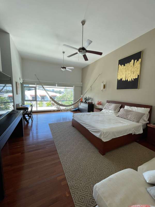 Spacious bedroom with vaulted ceiling, hammock, modern furniture at PH Bianco Loft Altos del Golf Panama