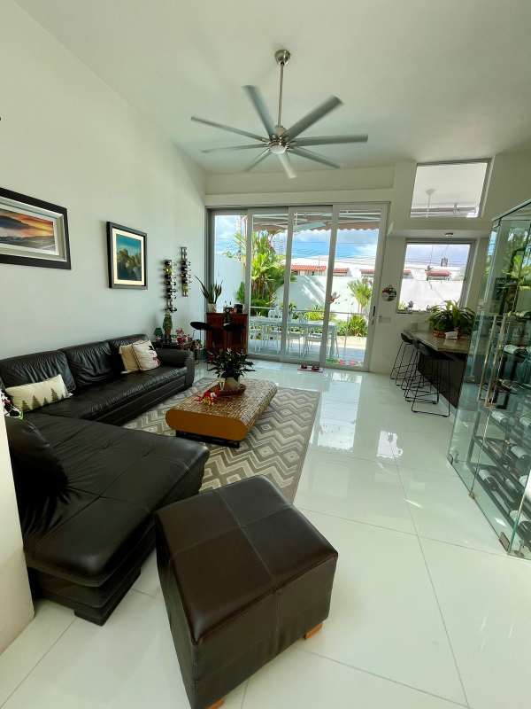 Minimalist bathroom featuring glass-enclosed shower, large mirror, and vessel sink at PH Bianco Loft Panama City