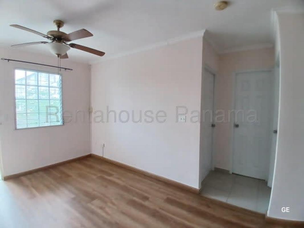 Bright bedroom with ceiling fan, laminate floors, and large window PH Parque Lefevre Panama City