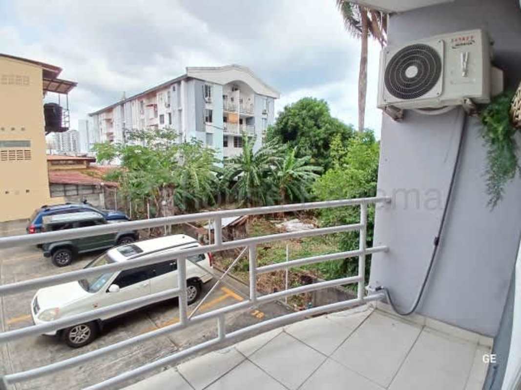 Private metal-railed balcony facing neighborhood and greenery PH Parque Lefevre Panama City