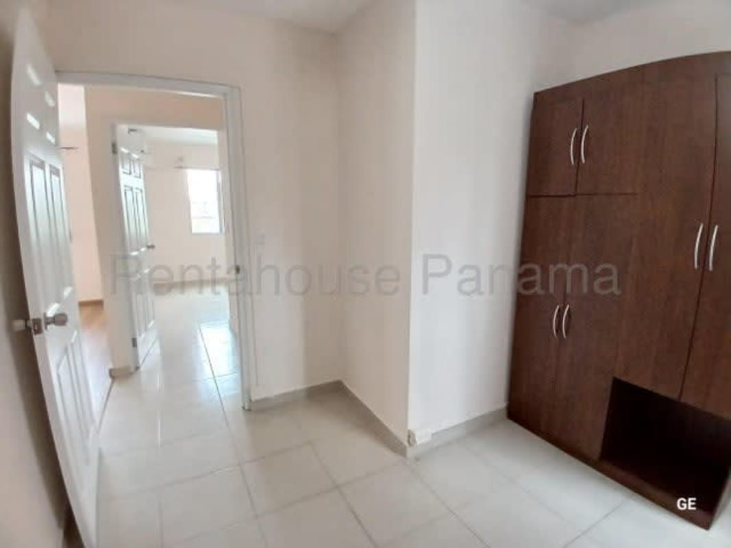 Apartment bedroom with wooden closet, tiled floor, natural light PH Parque Lefevre Panama City