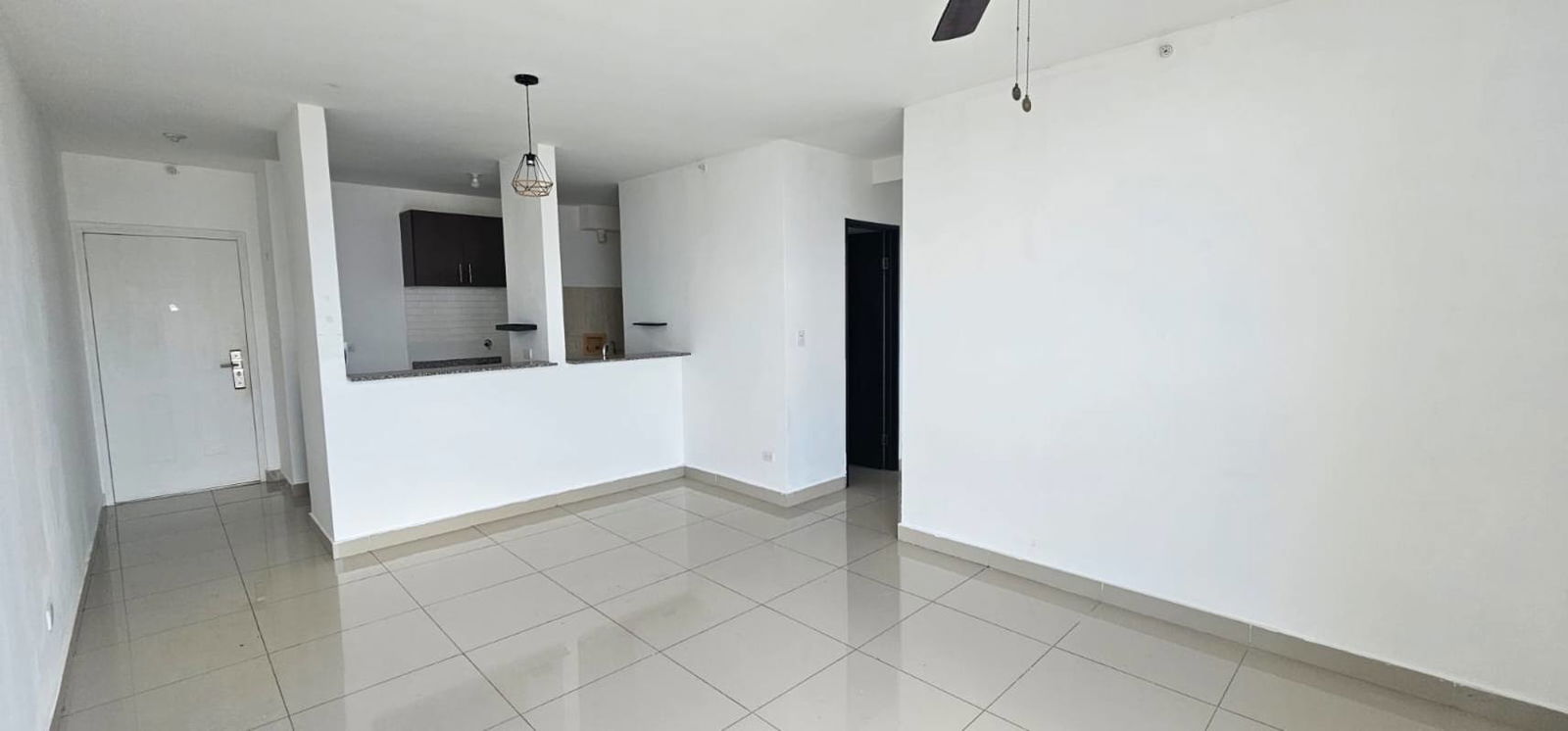 Open living and dining space with kitchen view tiled floors PH Park City Panama