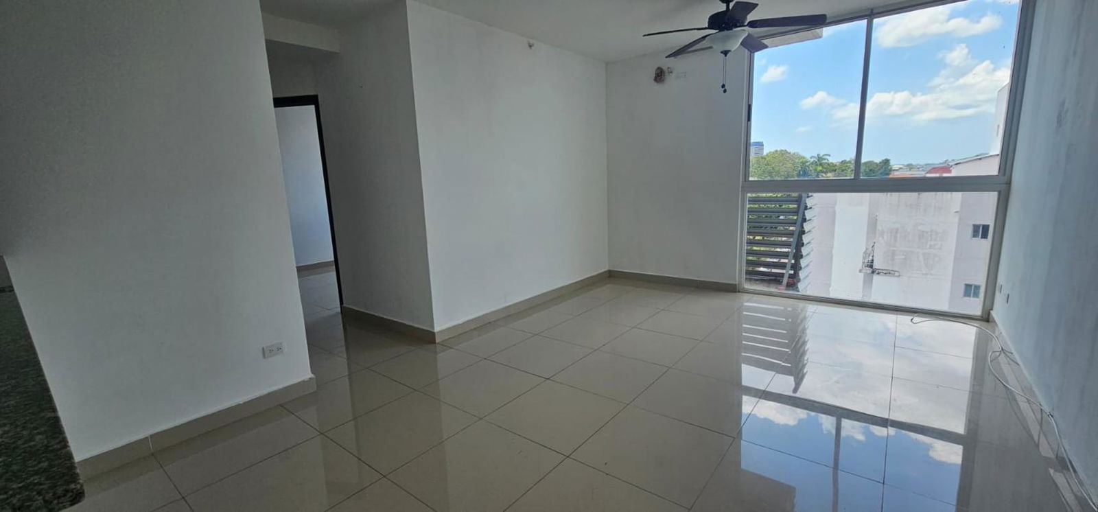 Spacious living room with big window, tiled floor, ceiling fan in PH Park City Bella Vista Panama