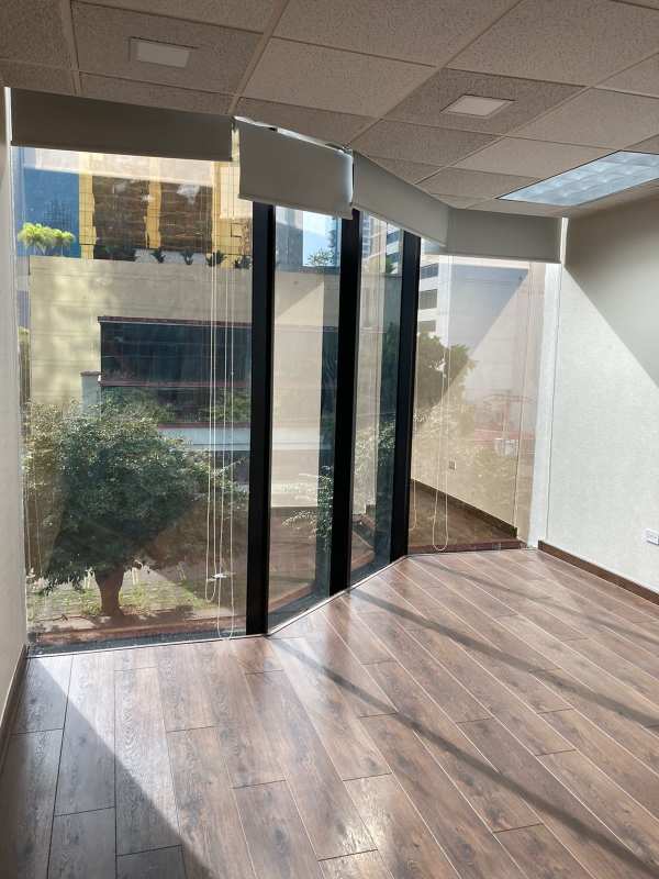 Bright office area with floor-to-ceiling window and city views plus office equipment Plaza Obarrio Panama
