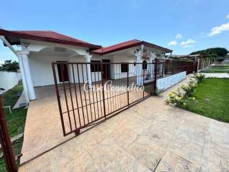 Exterior of house with red roof white facade driveway and garden in San Carlitos David Panama for rent