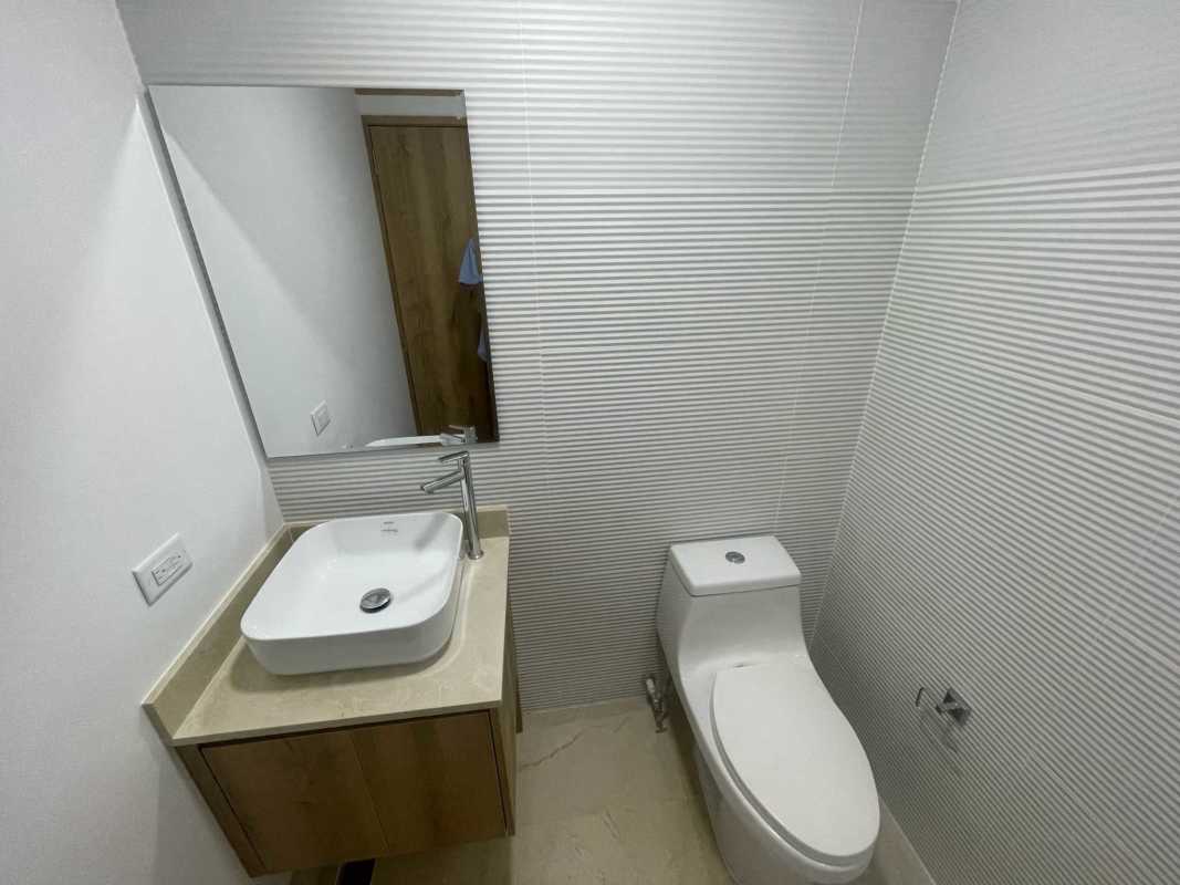 Modern minimalist bathroom with vanity and tile walls in commercial building Panama City