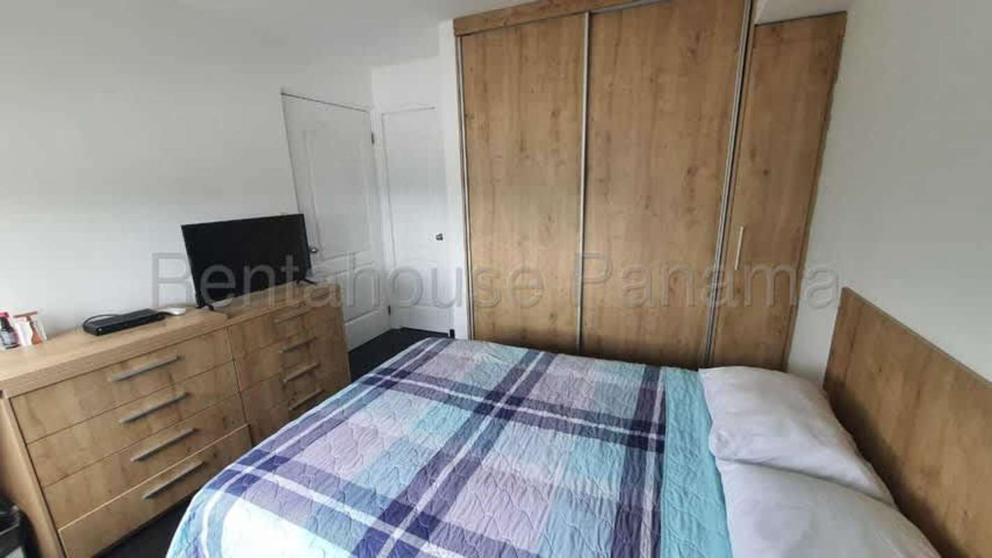 Small kitchen with laundry appliance, wooden cabinetry at PH Majestic Garden Edison Park Panama