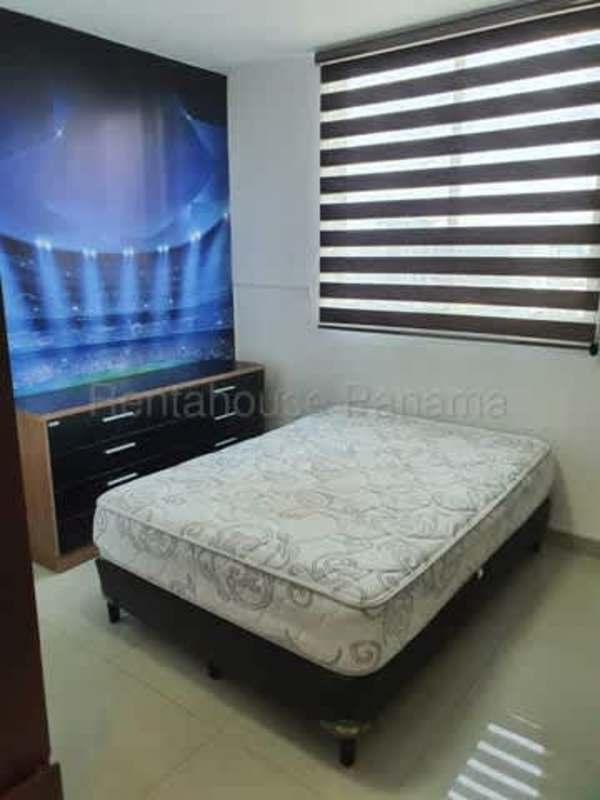 Dining area next to sliding doors leading to balcony with city skyline view, PH Diamond Tower Panama