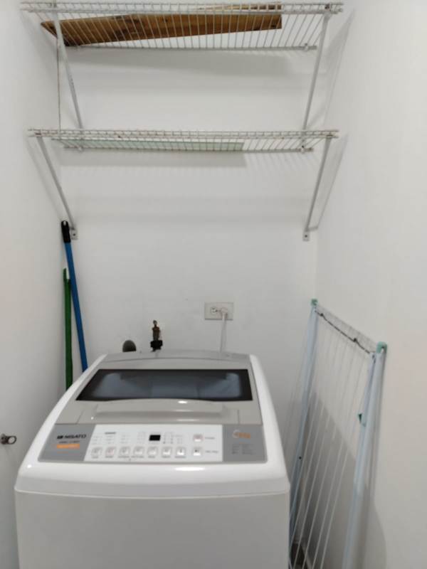 Practical laundry area with utility sink and window in PH Mystic Tower apartment Panama