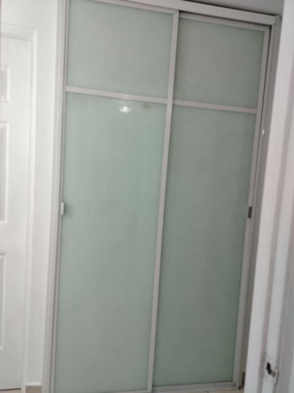 Bedroom with closet space, tile flooring and window PH Mystic Tower Panama City