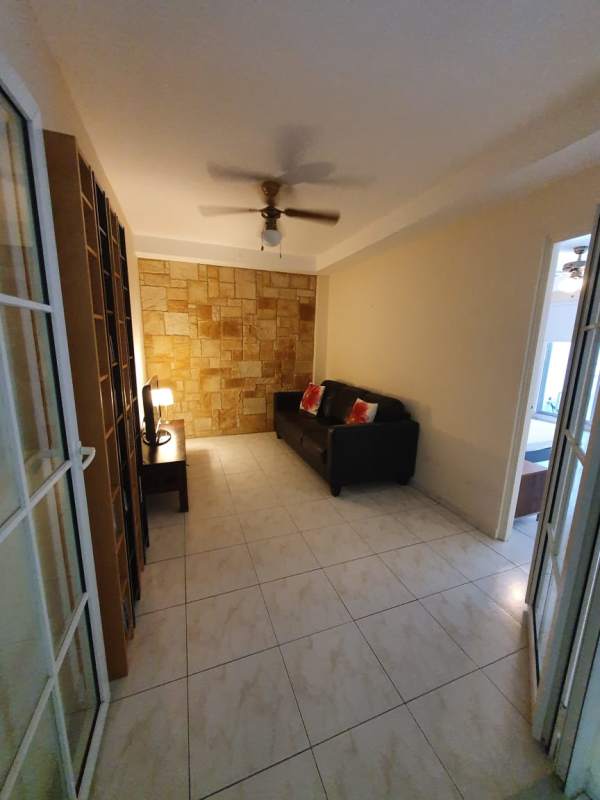 Bright open living and dining room with tile floors, ceiling fans, large windows apartment Ciudad del Saber Panama