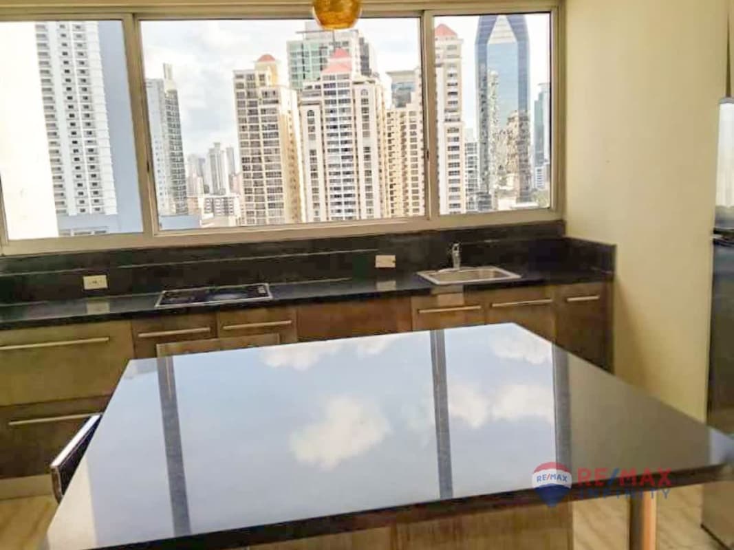 Kitchen with granite countertop island, city views at PH Denovo in Obarrio Panama City