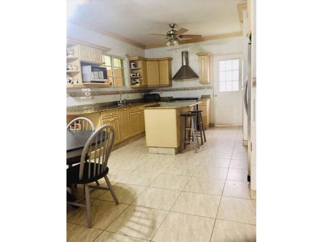 Kitchen with granite counters, wood cabinets, island Costa Bay house Panama