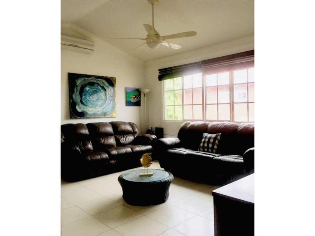 Contemporary living room with leather sofas, window, AC Costa Bay house Panama