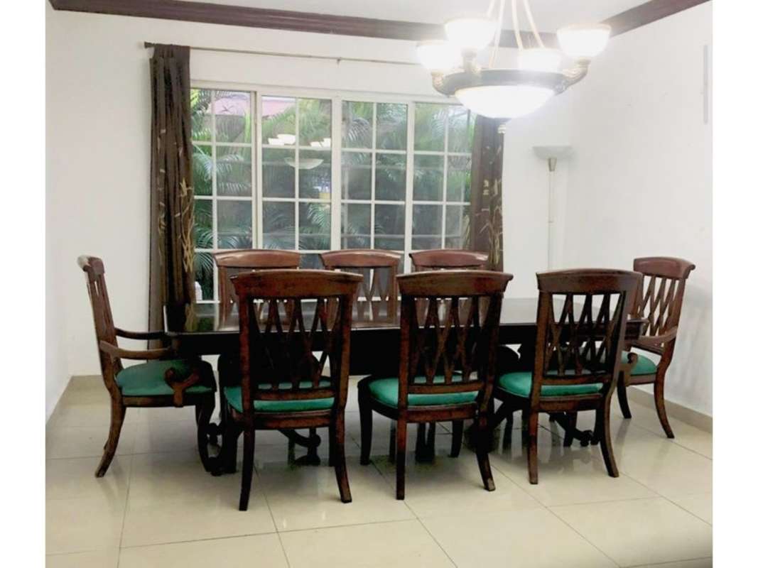 Dining room with wood furniture and window garden view Costa Bay Costa del Este