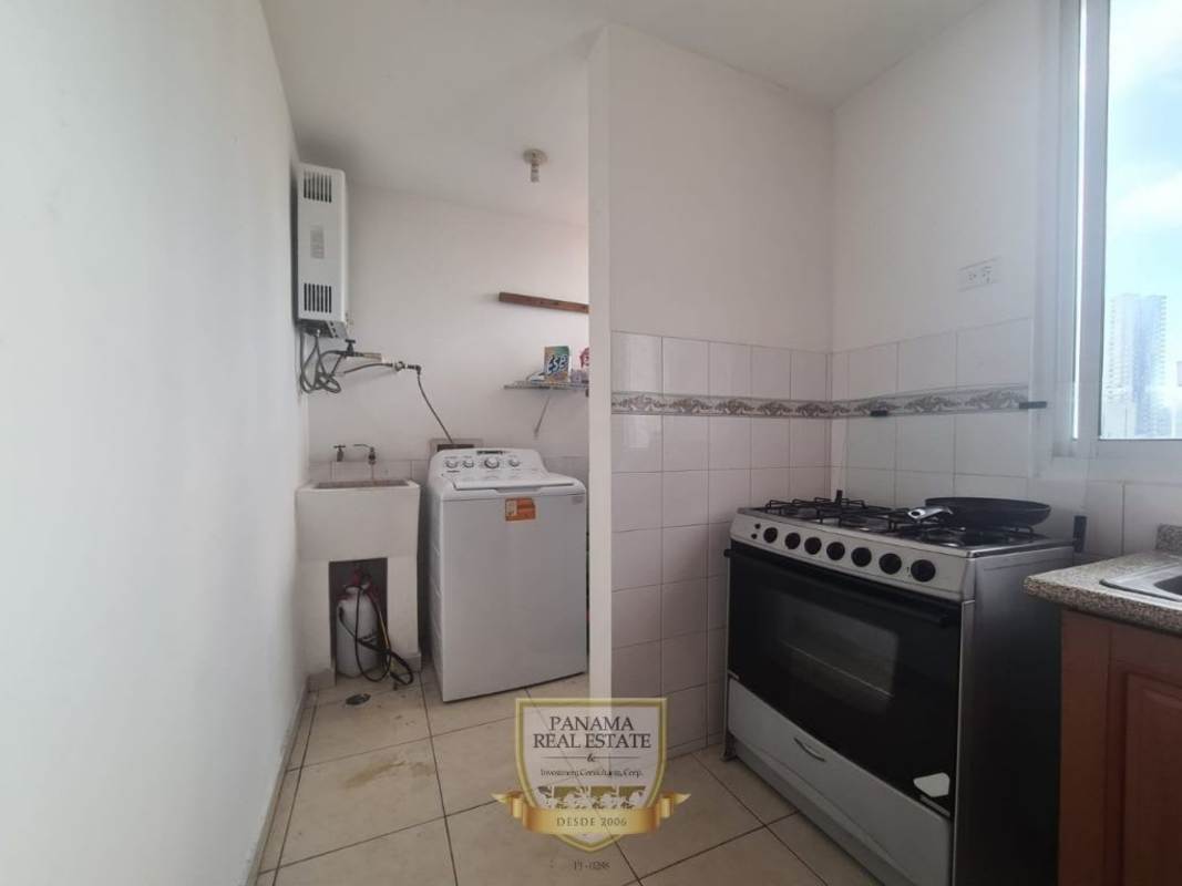 Kitchen with appliances, laundry and window view in PH Porto Bello apartment Panama